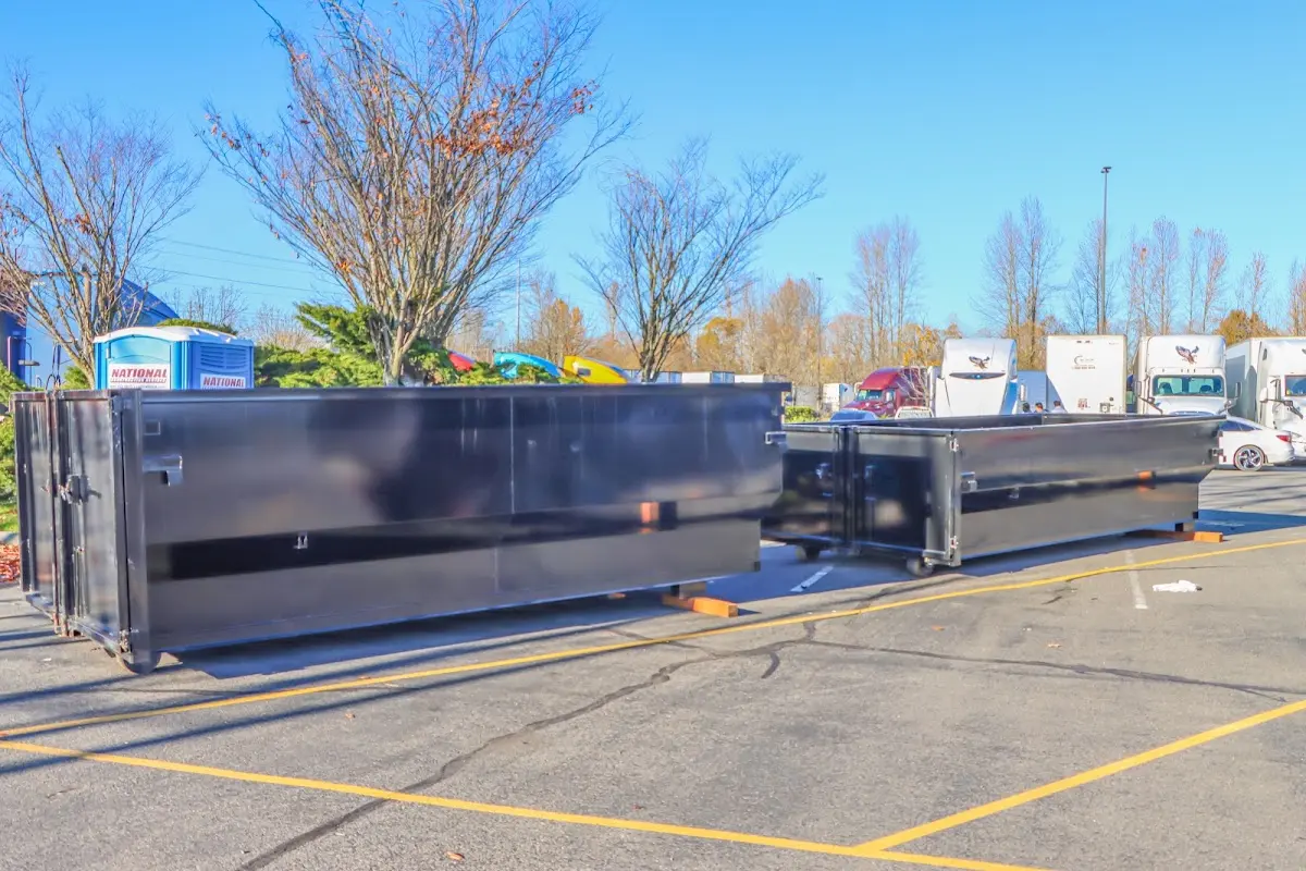 Professional dumpster rental service with roll-off container on residential driveway in Charleston